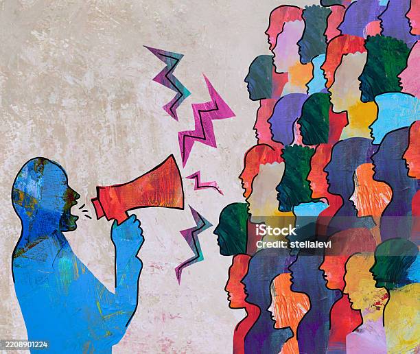 Man speaking holding megaphone and his audience listening
